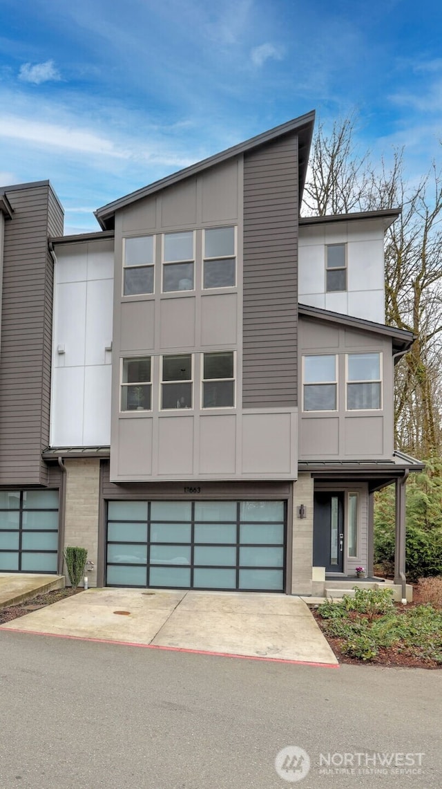 modern home featuring concrete driveway and an attached garage