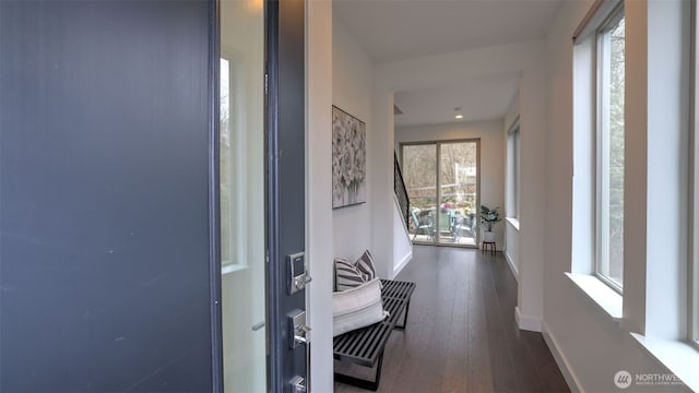 hall featuring wood finished floors and baseboards