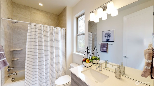 bathroom with toilet, shower / tub combo, and vanity