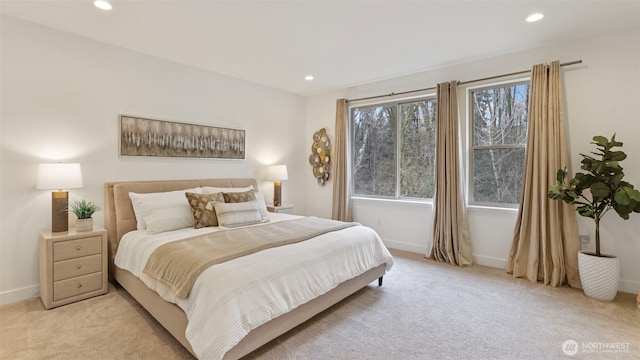 bedroom with recessed lighting, light colored carpet, and baseboards