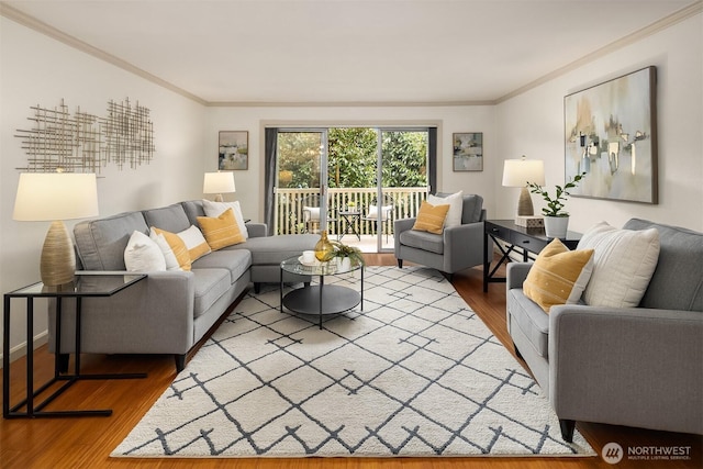 living area featuring ornamental molding and wood finished floors