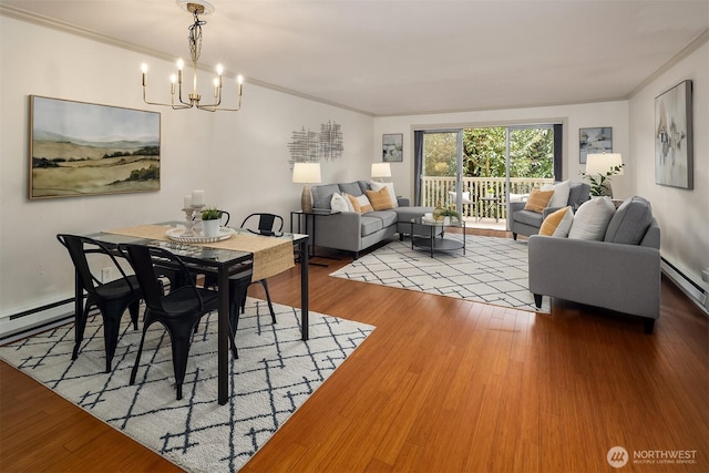 dining area featuring crown molding, a notable chandelier, and wood finished floors