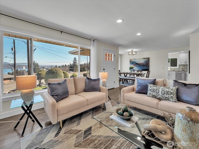 living room with recessed lighting, baseboards, and wood finished floors