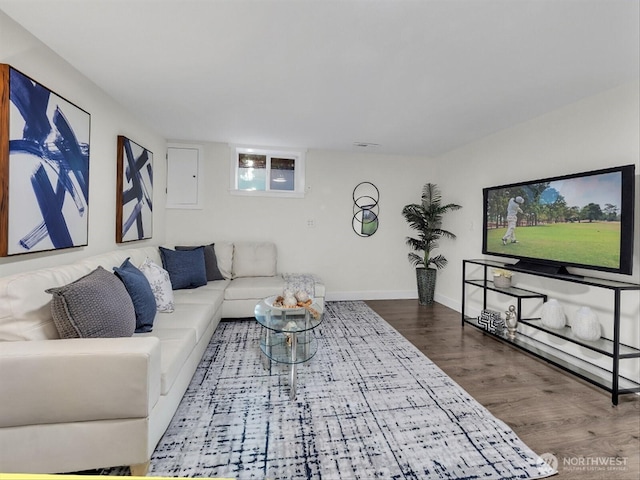 living area featuring baseboards and wood finished floors