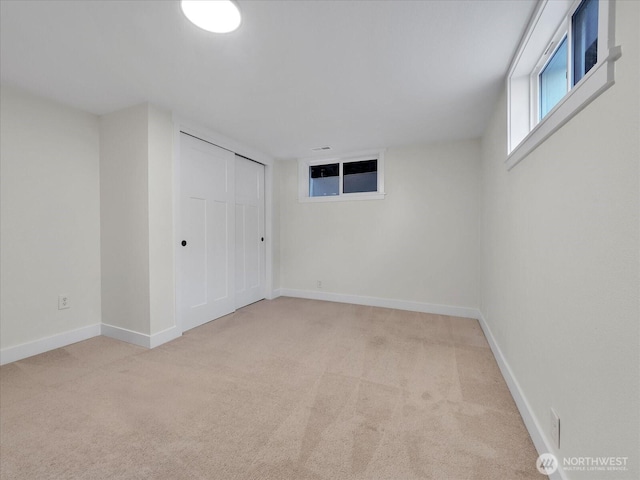 empty room featuring carpet flooring and baseboards