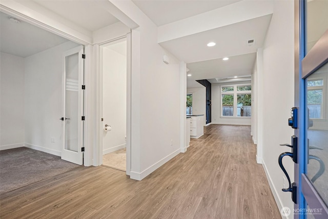 entryway featuring recessed lighting, wood finished floors, and baseboards