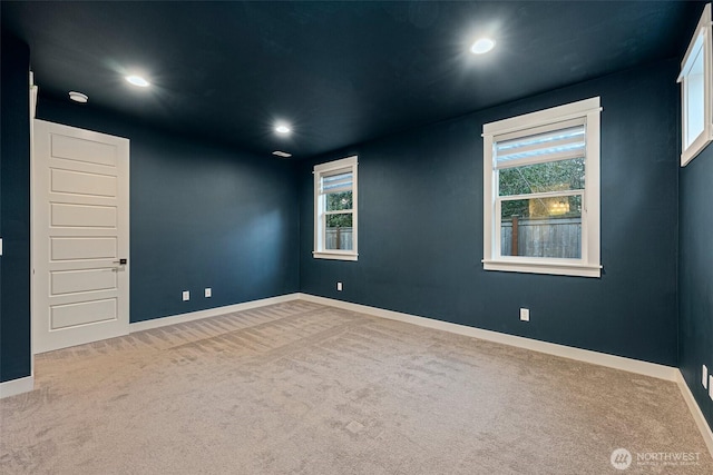 carpeted spare room featuring recessed lighting and baseboards