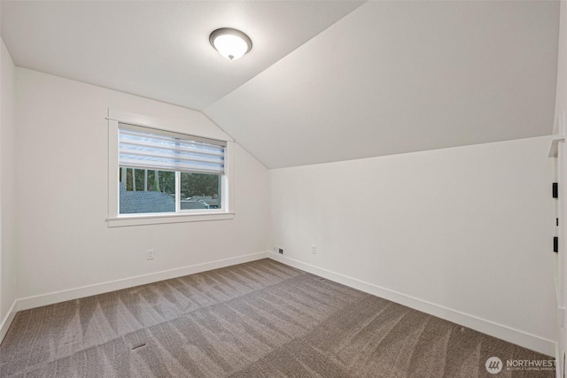 bonus room featuring lofted ceiling, carpet, and baseboards