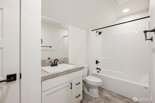 bathroom featuring tub / shower combination, vanity, and toilet