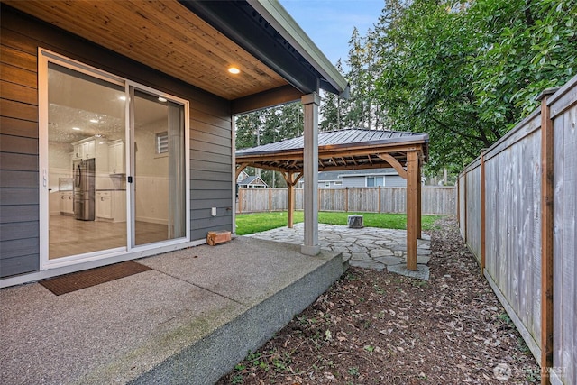 view of patio with a fenced backyard and a gazebo