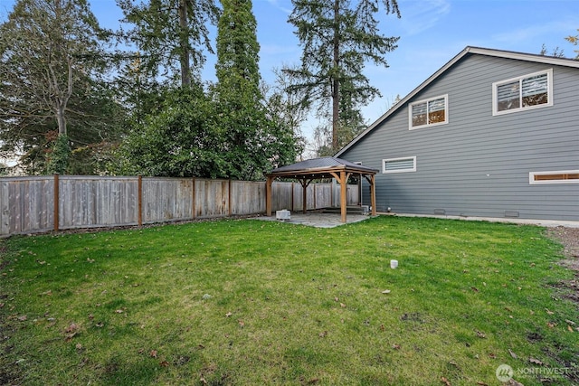 view of yard featuring a gazebo, a patio area, and a fenced backyard