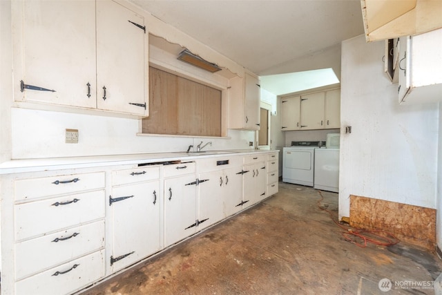 kitchen with washer and clothes dryer, unfinished concrete floors, light countertops, and a sink