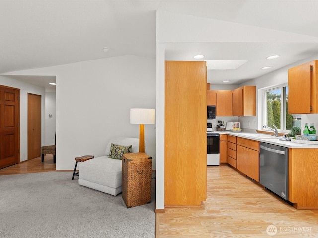 kitchen with a sink, range with electric stovetop, stainless steel dishwasher, black microwave, and light countertops