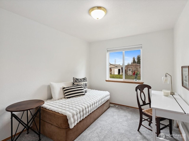 carpeted bedroom featuring baseboards