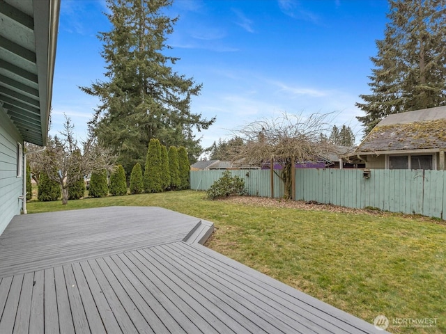 deck with a lawn and fence