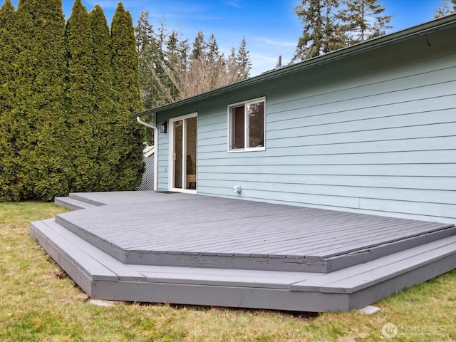 wooden terrace featuring a yard