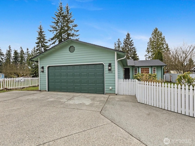 ranch-style home with fence, a garage, and driveway