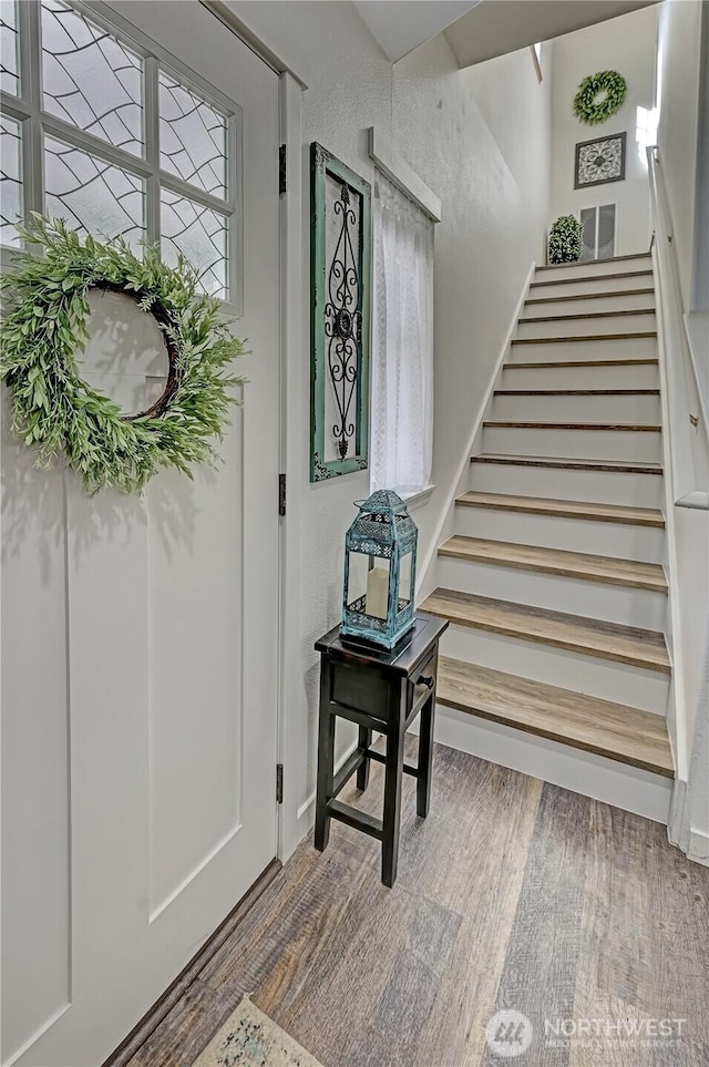 staircase with wood finished floors