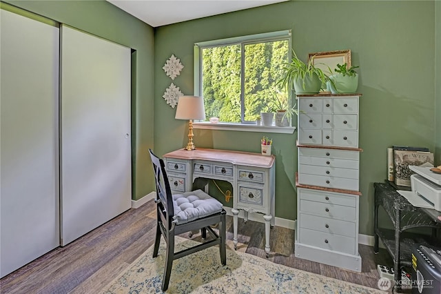 office with baseboards and wood finished floors