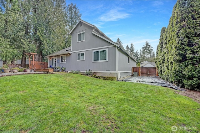 back of property featuring a patio, a lawn, and fence