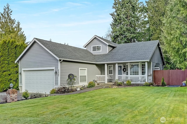 view of front facade with a front yard, a porch, and an attached garage