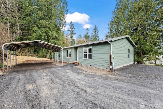 view of front of home featuring a carport, crawl space, driveway, and entry steps