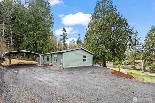 view of front of property with a carport and driveway