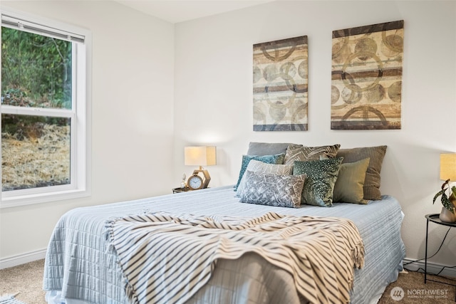 carpeted bedroom featuring baseboards