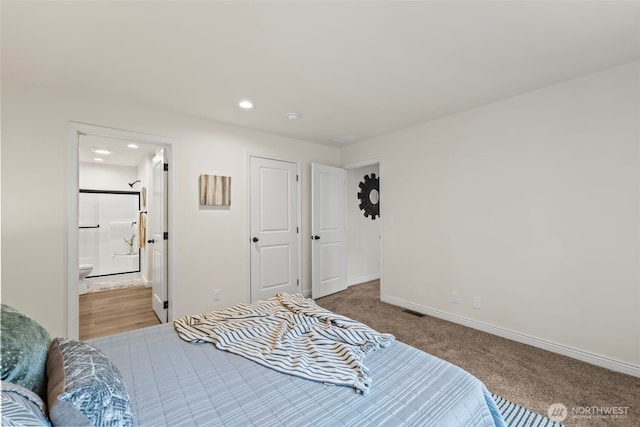 bedroom featuring visible vents, baseboards, carpet flooring, recessed lighting, and ensuite bath