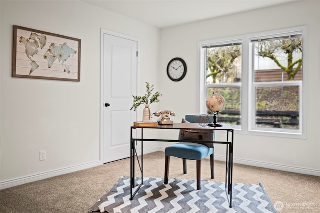 carpeted office space with baseboards