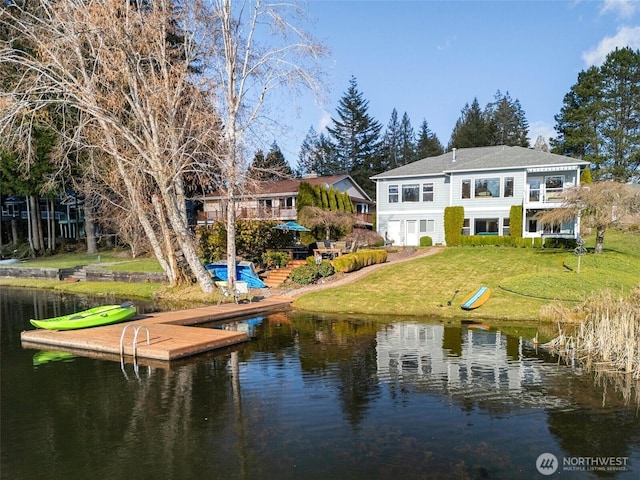 back of property featuring a yard and a water view