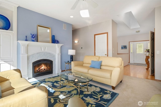 living area with recessed lighting, a fireplace, wood finished floors, visible vents, and a ceiling fan