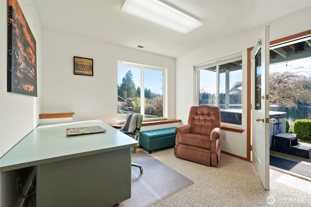 office space featuring plenty of natural light, visible vents, and baseboards