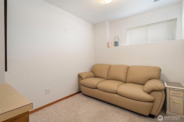 living room featuring light carpet and baseboards