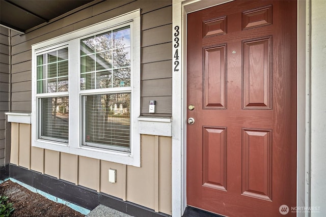 doorway to property featuring board and batten siding