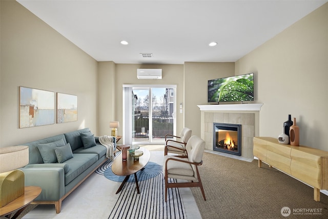 living area featuring visible vents, recessed lighting, a fireplace, and an AC wall unit