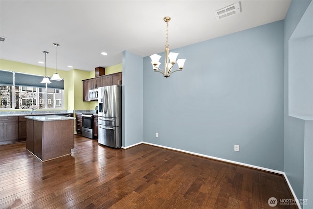 kitchen featuring visible vents, dark wood-style floors, appliances with stainless steel finishes, light countertops, and dark brown cabinets