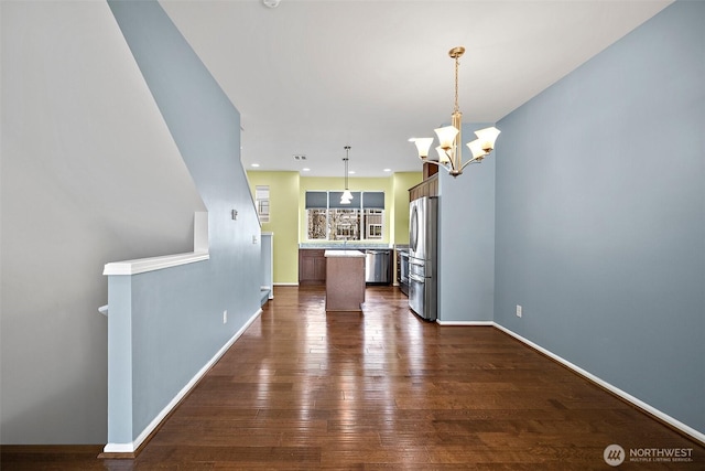 interior space with an inviting chandelier, recessed lighting, baseboards, and dark wood-style flooring