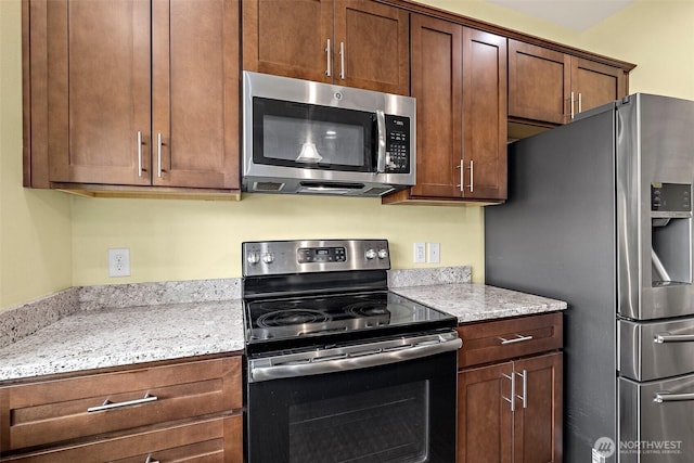 kitchen featuring light stone countertops and appliances with stainless steel finishes