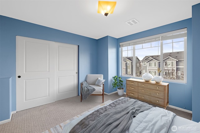 bedroom featuring visible vents, baseboards, and carpet floors