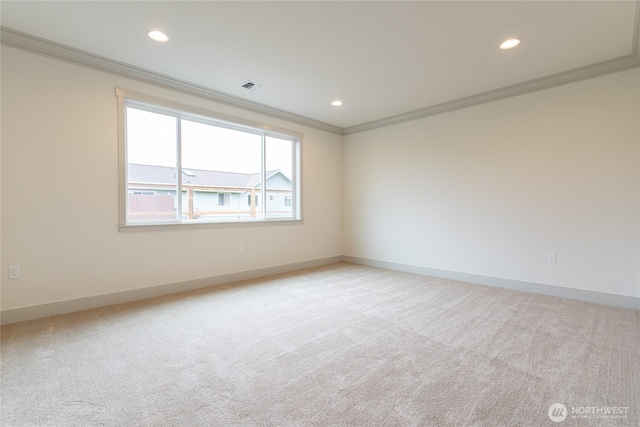 empty room featuring light carpet, recessed lighting, baseboards, and ornamental molding