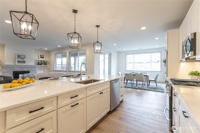 kitchen featuring a wealth of natural light, open floor plan, appliances with stainless steel finishes, and a sink