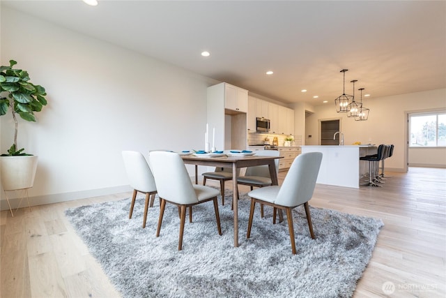 dining area featuring recessed lighting, baseboards, and light wood-style floors