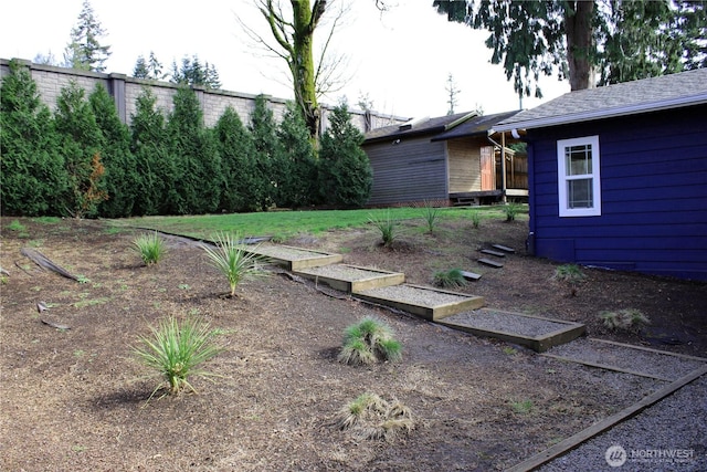view of yard featuring a garden and fence