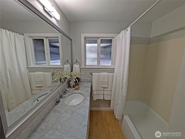 full bathroom featuring wood finished floors, vanity, and shower / bath combination with curtain