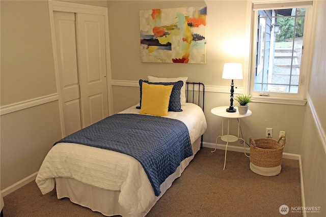 bedroom with a closet, baseboards, and carpet floors