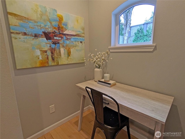 office area with baseboards and wood finished floors