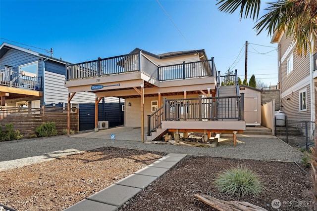 rear view of property with a patio area, stairway, a wooden deck, and fence