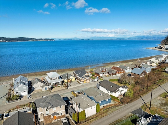 drone / aerial view featuring a residential view and a water view