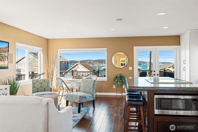 interior space with recessed lighting, french doors, baseboards, and dark wood-style flooring